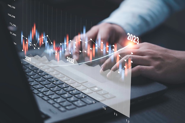 Trader or Fund manager using computer laptop to drawing technical graph and chart for analysis stock market technology investment and value investment concept