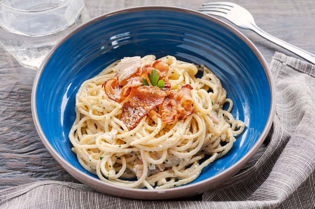 Tradition Italian food pasta carbonara, Spaghetti with bacon, ham and parmesan cheese on t