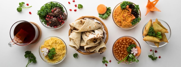 Traditional Arabic breakfast with hummus olive beans bread samosa and coffee isolated on table top view of arabian food