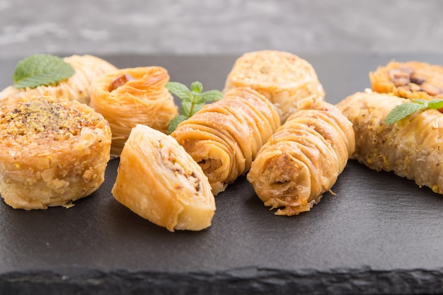 Traditional arabic sweets on a black slate board. side view