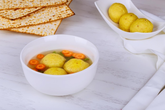 A traditional ashkenazi jewish soup with matzo balls made from a mixture of matzah meal chicken boui