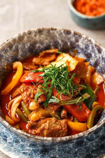 Traditional asian shurpa soup with lamb and vegetables