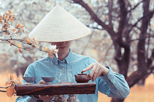 traditional asian tea ceremony in spring blooming garden abstract china background