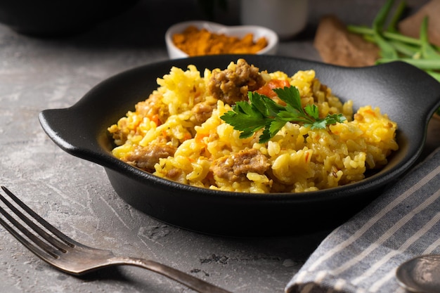 Traditional azian pilaf served in plate on gray background