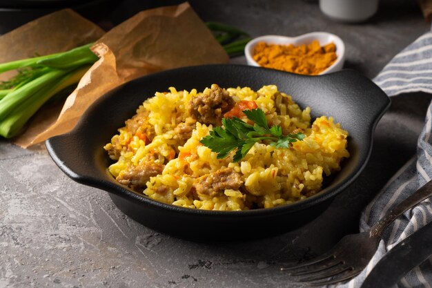 Traditional azian pilaf served in plate on gray background