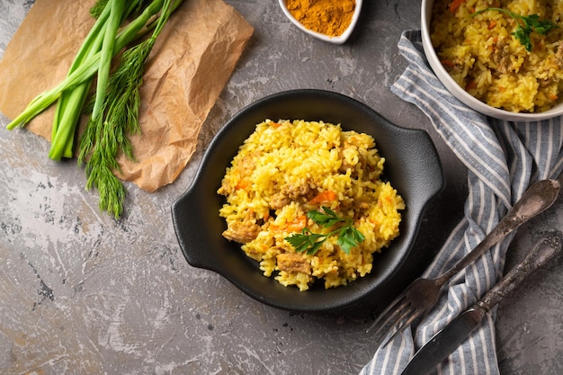 Traditional azian pilaf served in plate on gray background