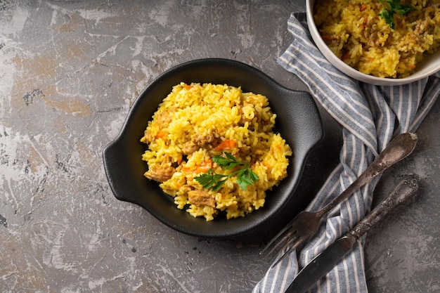 Traditional azian pilaf served in plate on gray background