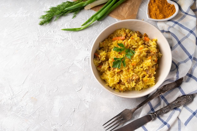 Traditional azian pilaf served in plate on gray background