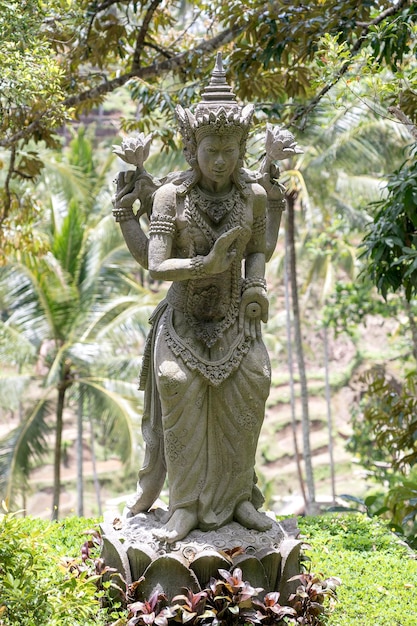 Traditional Balinese stone statue depicting god or mythological deity in Ubud island Bali Indonesia close up