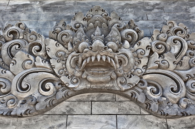 Traditional balinese temple old decoration for religious holiday festival and ceremony - carved hindu protective spirit Bhoma.