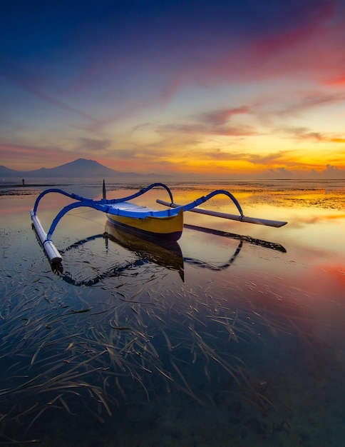 Traditional boat with nice color sunrise