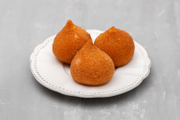 Traditional brasilian fried drumsticks Coxinha de frango on dish