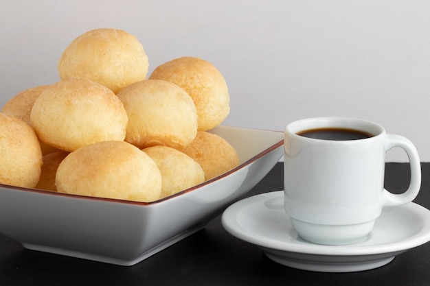 Traditional Brazilian cheese bread (pao de queijo) with a cup of coffee.