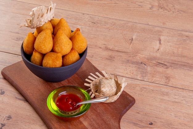 Traditional Brazilian fried snack stuffed with chicken and ketchup