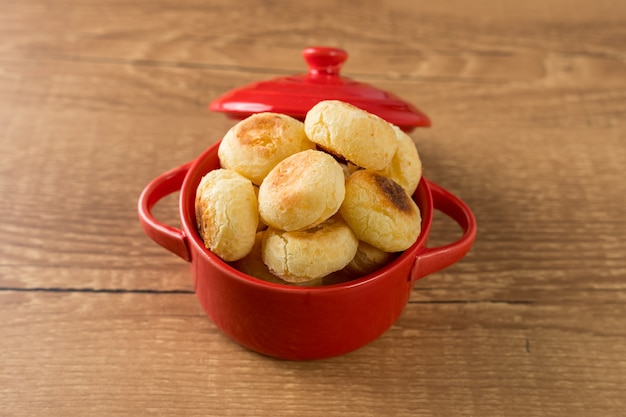 Traditional Brazilian Snack Cheese Bread in a rustic red cooking pot