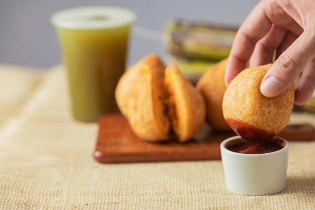 Traditional brazilian snack. Coxinha of chicken and cane juice.