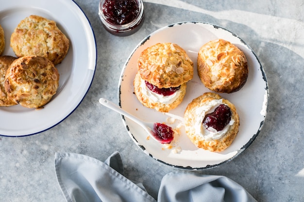 Traditional british scones with clotted cream, raspberry jam