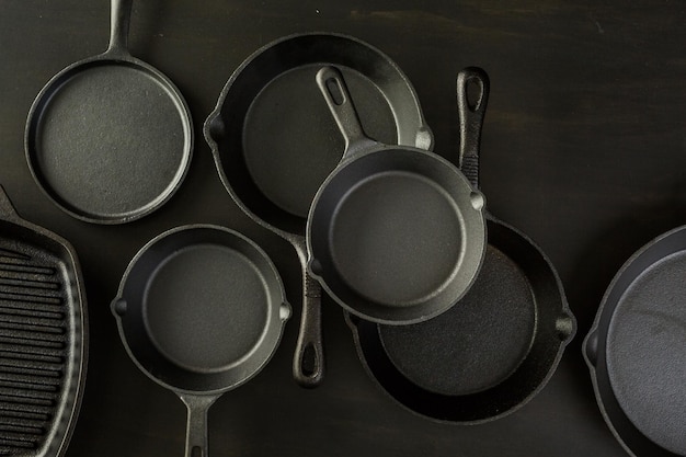 Traditional cast iron skillet on black wood table.