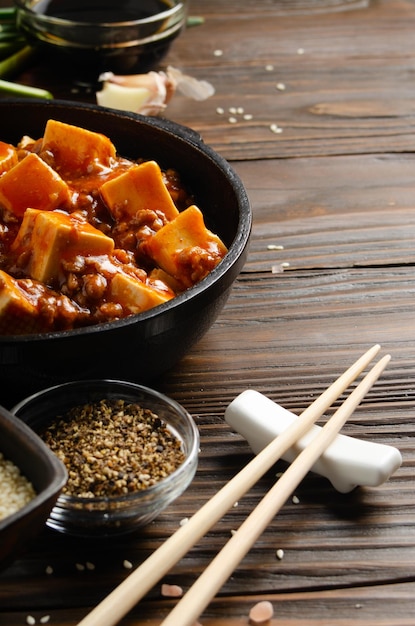 Traditional Chinese food mapo tofu dish with pork chives soy sauce sichuan pepper garlic and spices