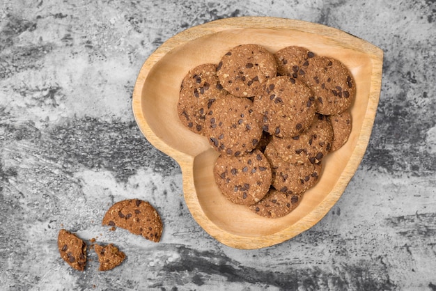 Traditional chocolate chip cookies on heart shape plate.