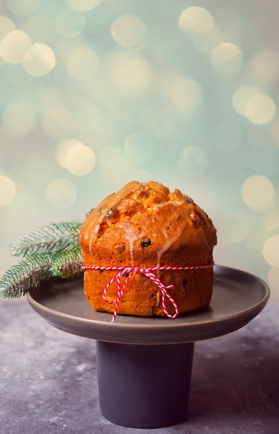 Traditional Christmas cake panettone with fruits and nuts with Christmas decoration