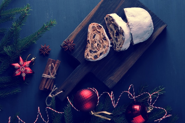 Traditional Christmas cake with raisins and nuts with tree branches and toys