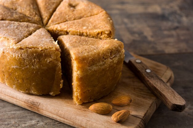 Traditional Christmas marzipan slice on wooden table