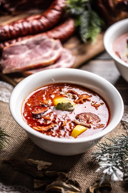 Traditional christmas sour cabbage soup with potatoes sausage smoked pork and mushrooms