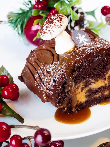 Traditional Christmas Yule Log cake decorated with marzipan mushrooms.