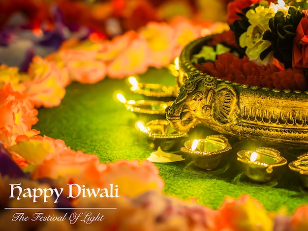 Traditional clay diya lamps lit with flowers for Diwali festival celebration. 