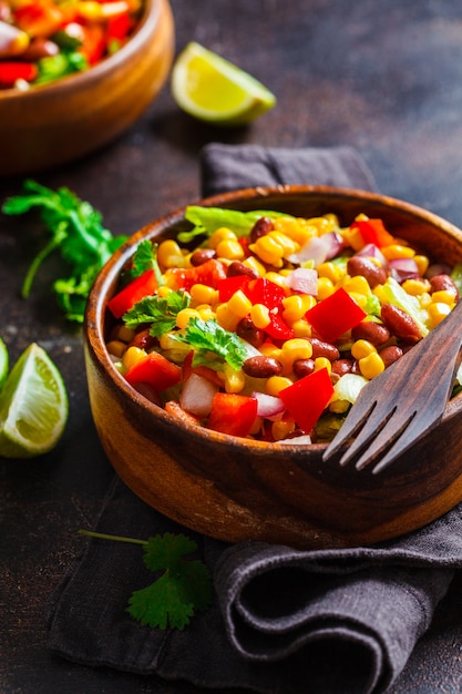 Traditional corn bean mexican salad in a wooden bowl