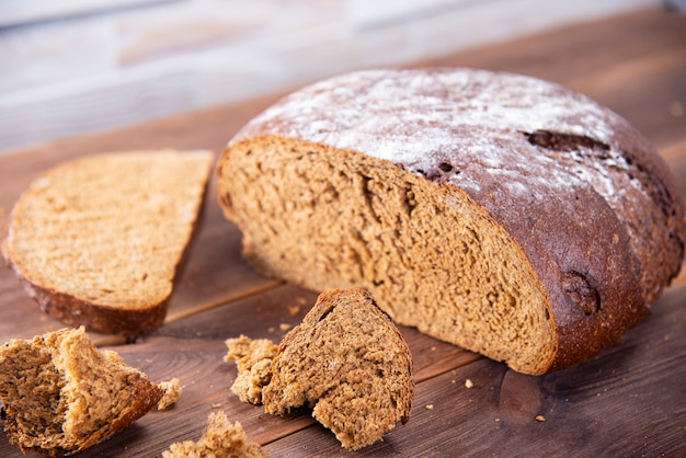 Traditional dark homemade bread sliced and broken into pieces