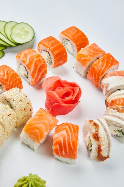 Traditional delicious fresh sushi set Philadelphia roll with salmon smoked eel and cucumber isolated on white background Sushi menu Japanese asian food