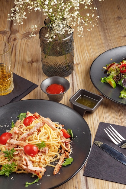 A traditional dish of Italian pasta cuisine restaurant serving black plate wooden table