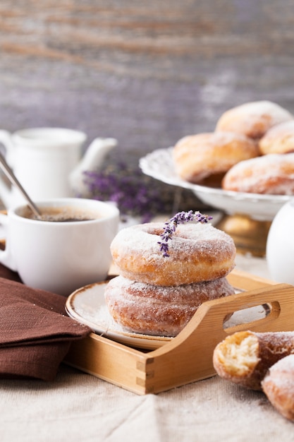 Traditional donuts on wood. Tasty doughnuts with  powdered sugar