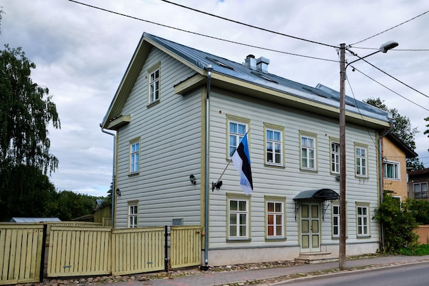 Traditional Estonian house of two floors with triangular roof and old fashioned wooden fence Tartu Estonia