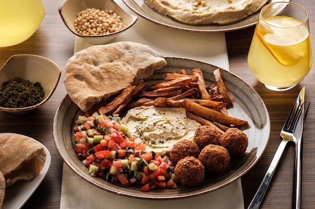 Traditional falafel balls with salad and hummus on a plate