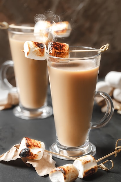 Traditional fall and winter cocktails, alcohol. Campfire hot chocolate cocktail with roasted marshmallow. Cocoa latte marshmallow