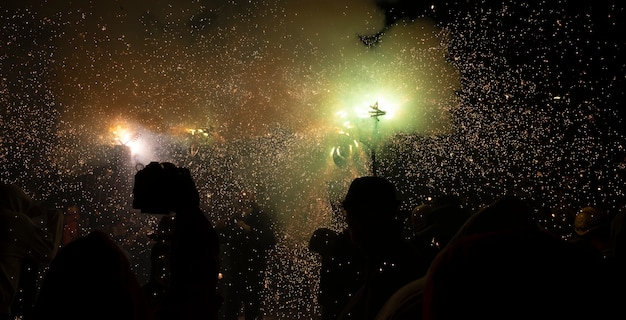 Traditional festival of Catalonia people dance under the fire and the sound of firecrackers