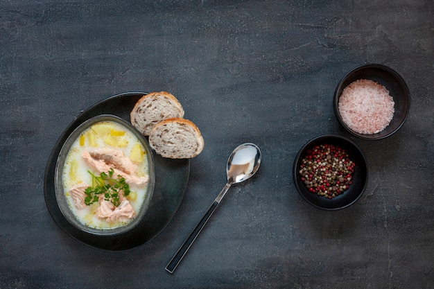 Traditional Finnish salmon soup Lohikeitto with potato, creme and lemon