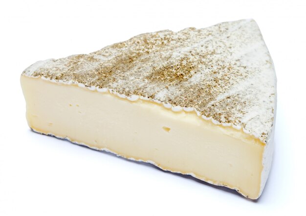 Traditional french brie cheese on a white table.