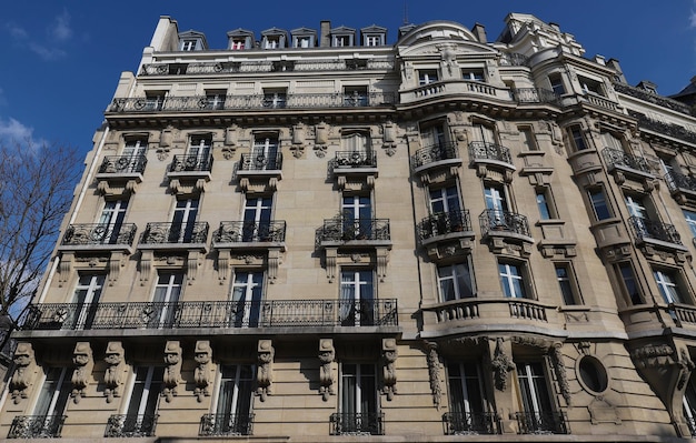 Traditional French house with typical balconies and windows Paris