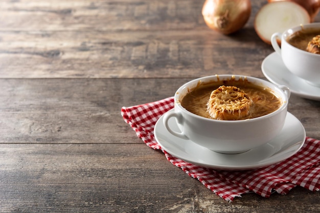 Traditional french onion soup on wooden table