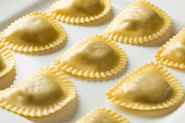 Traditional fresh Italian Mezzelune pasta stuffed with Mozzarella and mushrooms