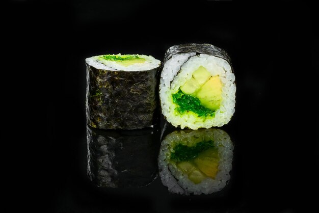 Traditional fresh japanese sushi rolls on a black background