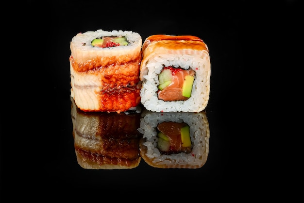 Traditional fresh japanese sushi rolls on a black background