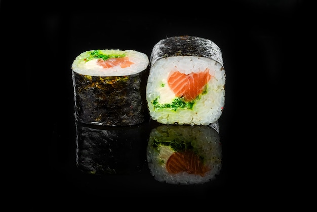 Traditional fresh japanese sushi rolls on a black background