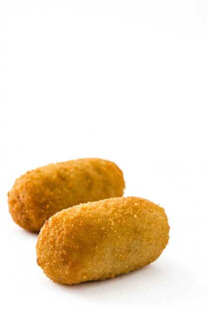 Traditional fried Spanish croquetas (croquettes) isolated on white background