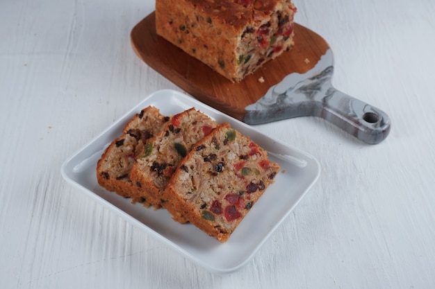 Traditional fruit cake pudding with dried fruits on white background