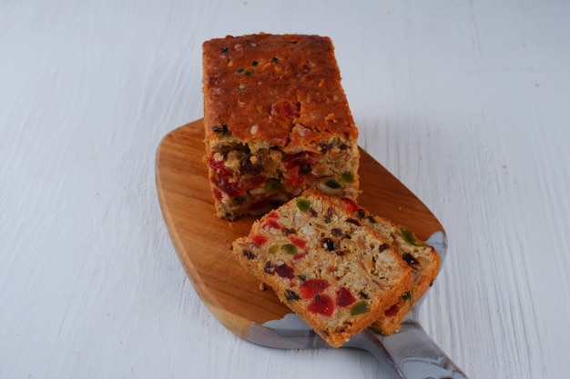 Traditional fruit cake pudding with dried fruits on white background